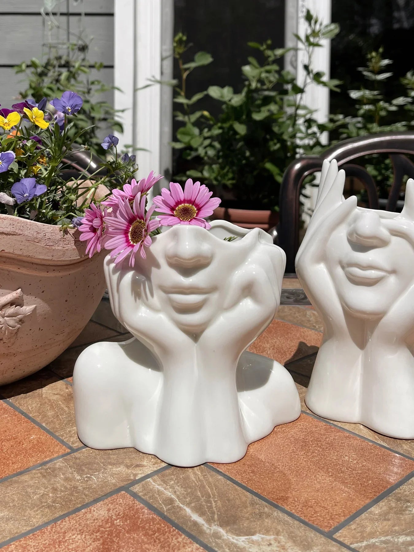 “Her” & Angelica Ceramic Vase Set of 2 on a patio in the Spring time.